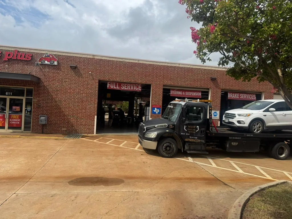 West Dallas Towing roadside assistance technician delivering vehicle to brake shop in Dallas